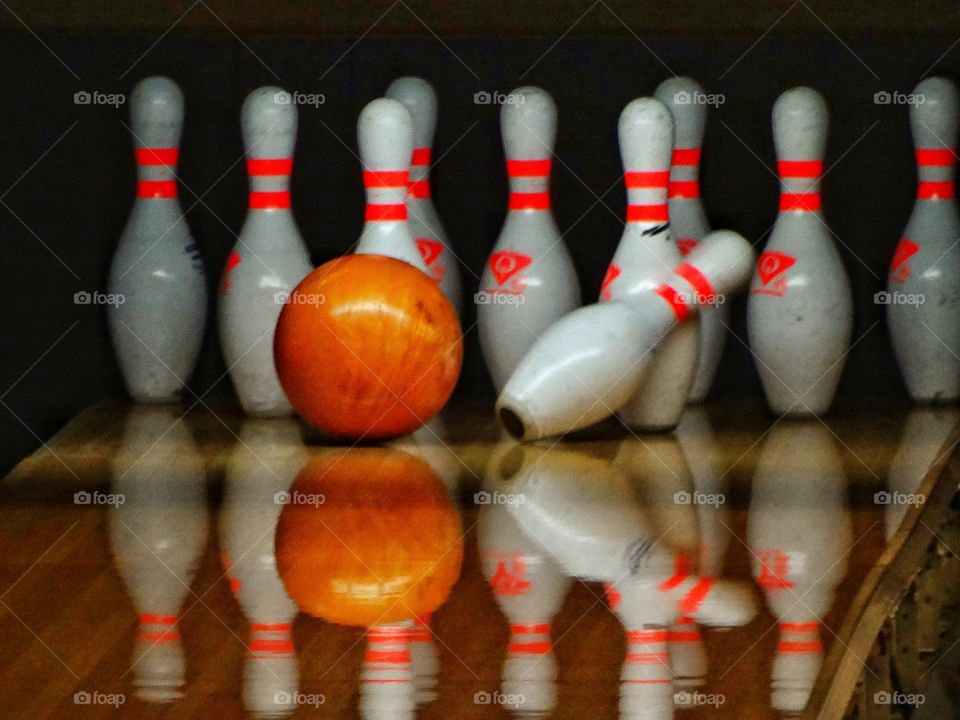 Bowling Ball knocking Down Pins