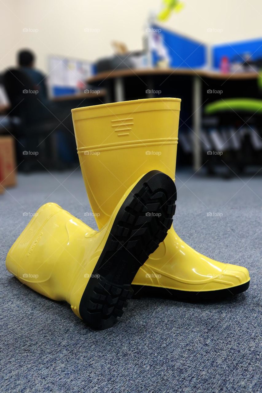 Yellow boots made of rubber, these shoes are usually worn by workers