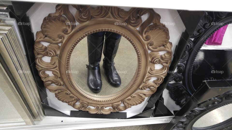 A reflection of boots in a mirror.