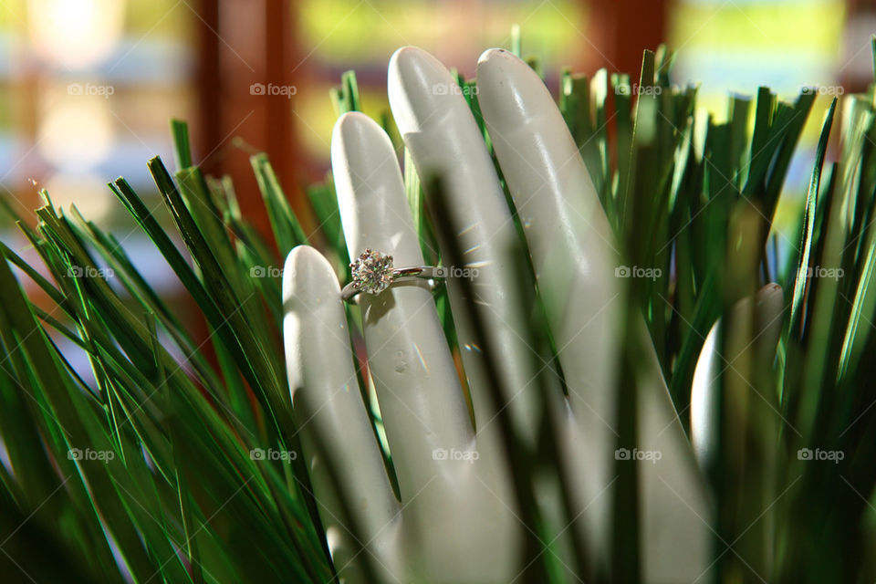 Magnificent engagement diamond ring gracefully placed on a mannequin's
