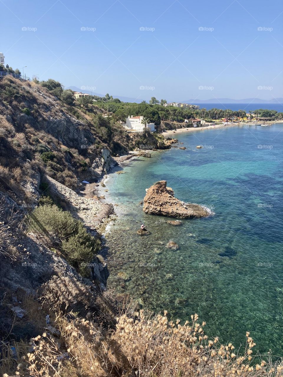 Beach time on holidays. Blue sky and tall palm trees. Sunsets and sunny days. Summertime in Kusadasi. Vacation travel in Turkey . Summer view. Sunny day during vacation 