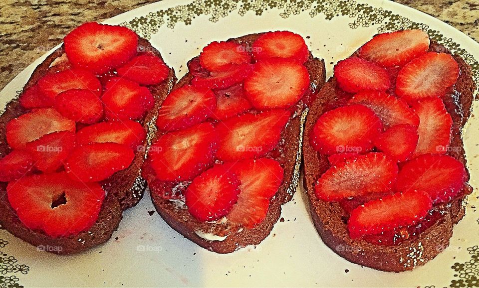 Strawberry toast! Fresh sliced strawberries and strawberry jam on pumpernickel rye toast with butter or cream cheese 