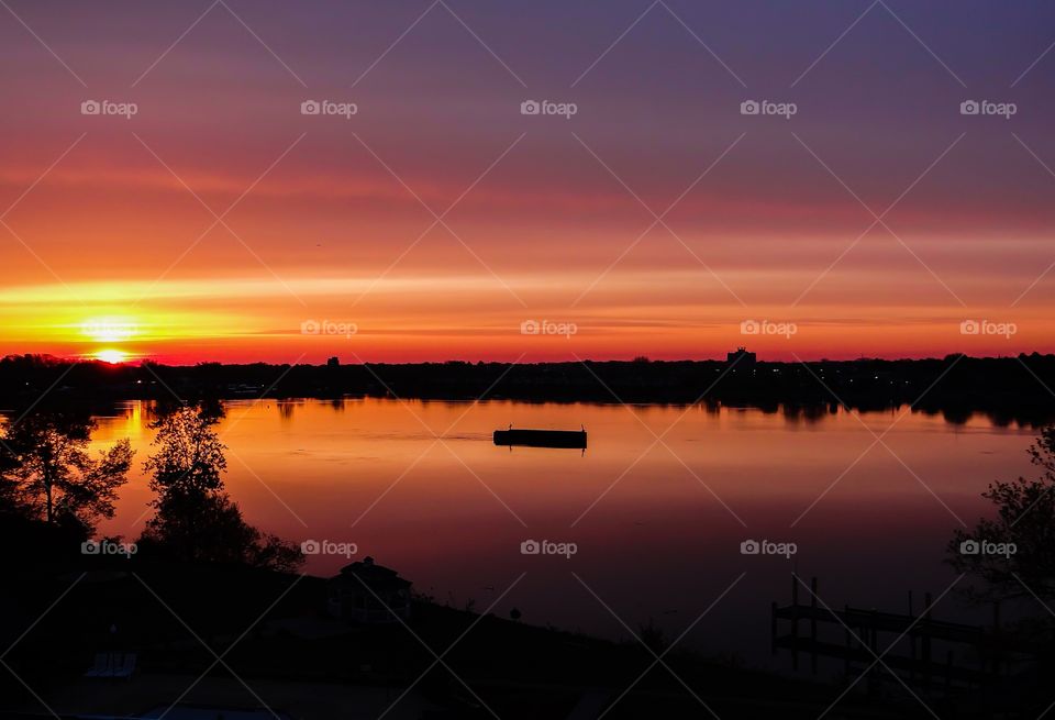 Dramatic sky during sunrise over lake