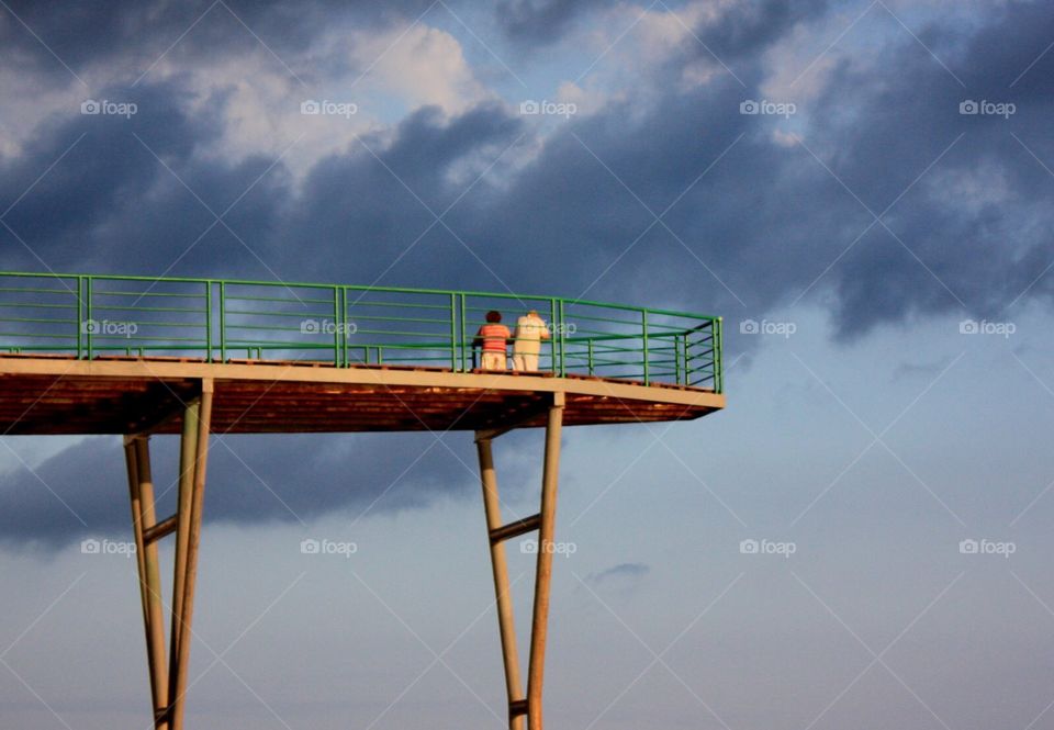 Couple on the top above the sea 