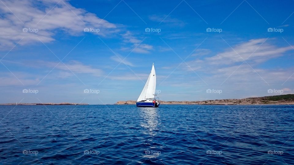 Sail boat on a blue ocean