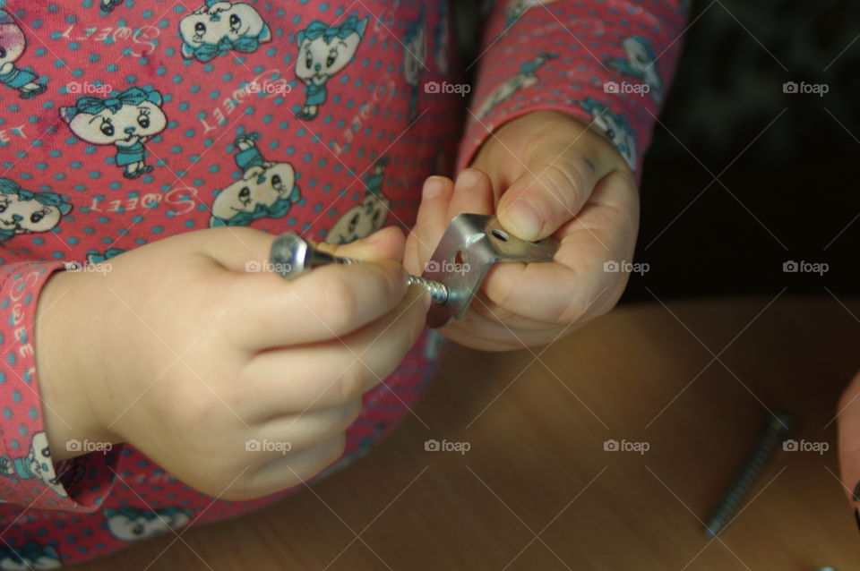 little girl holding tools