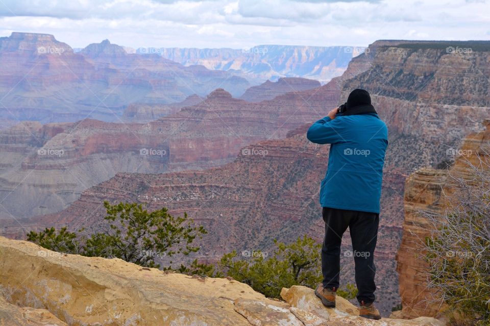 Man taking pictures of the Grand Canyon