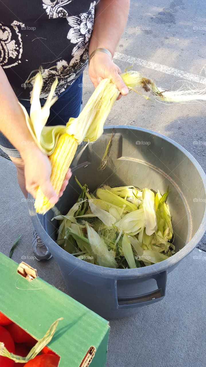 Lady peeling corn