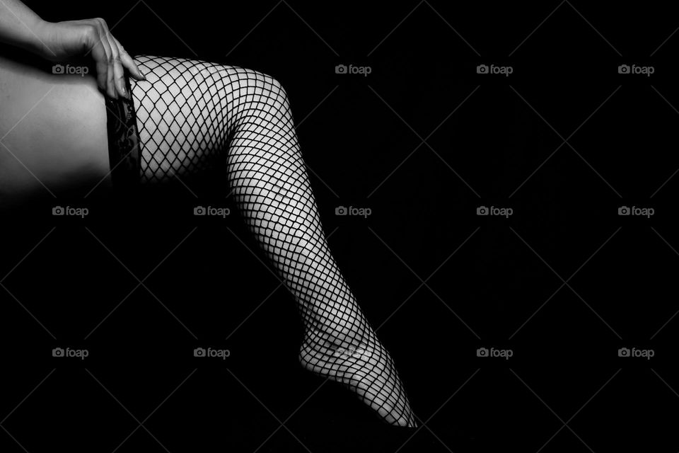Leg in garter in black and white