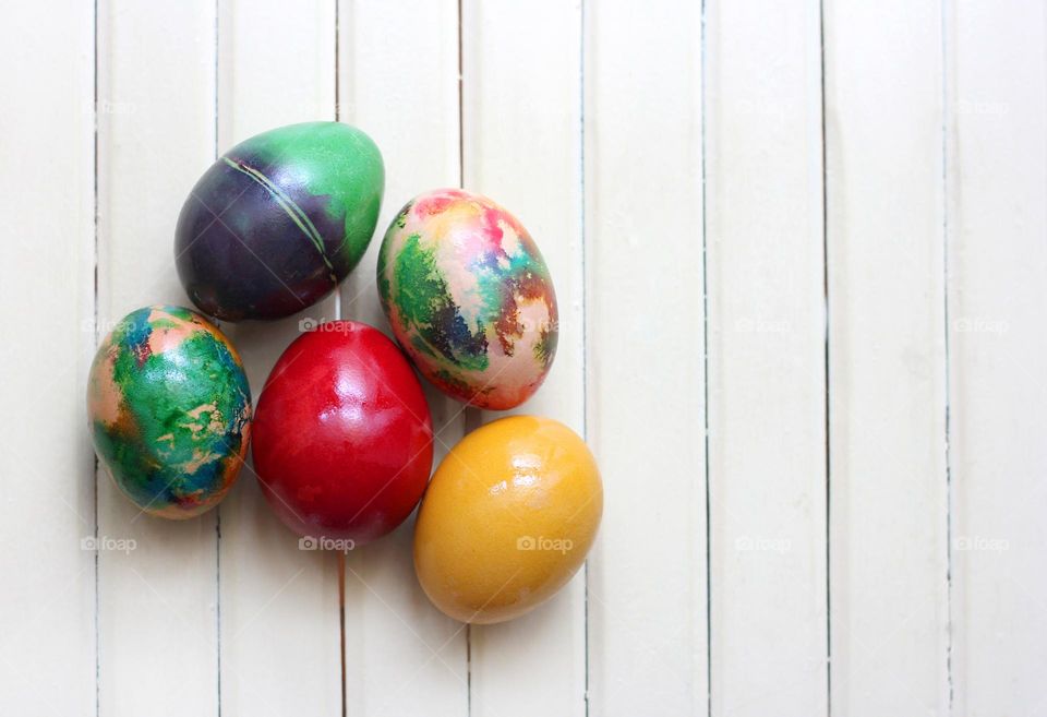 Easter eggs on white wooden background