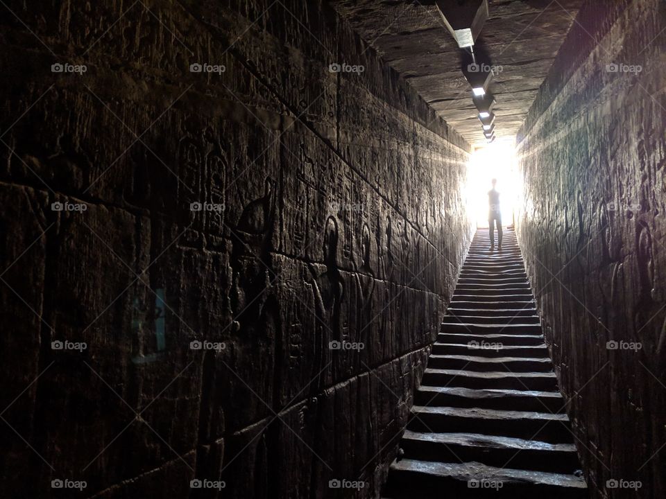 Descending the stairs inside the Temple of Edfu in Edfu, Egypt.