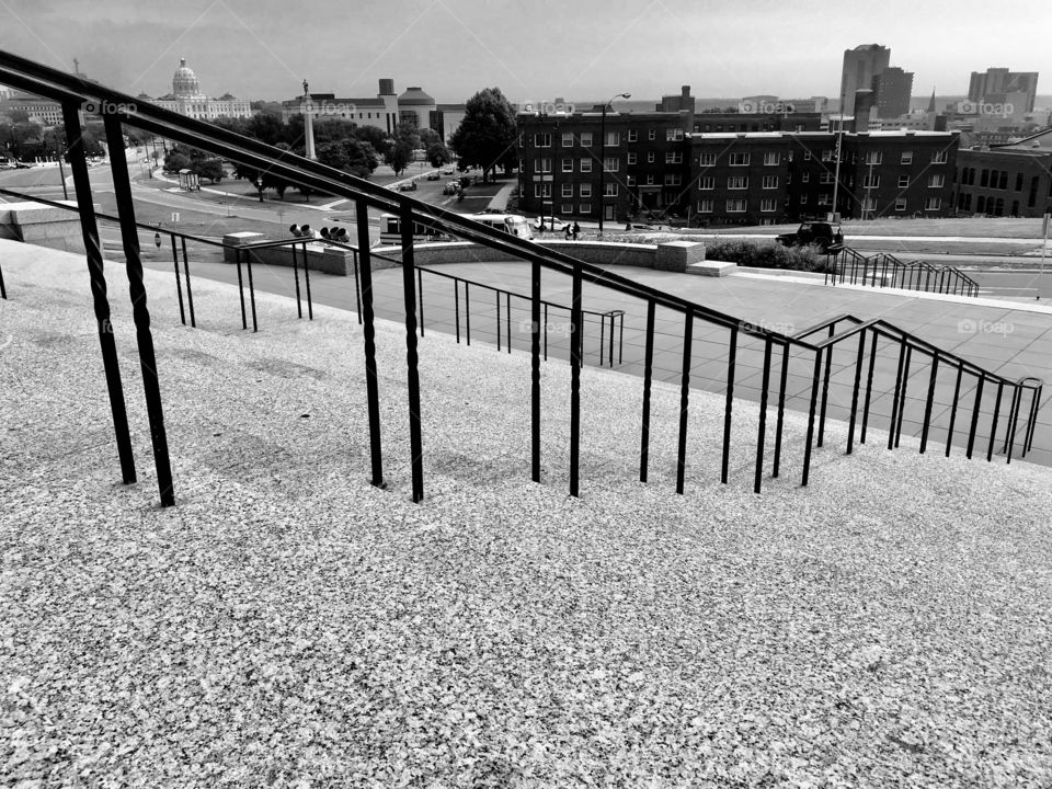 Fun black and white photo of rectangular shaped black railing on steps leading up to catholic cathedral! 