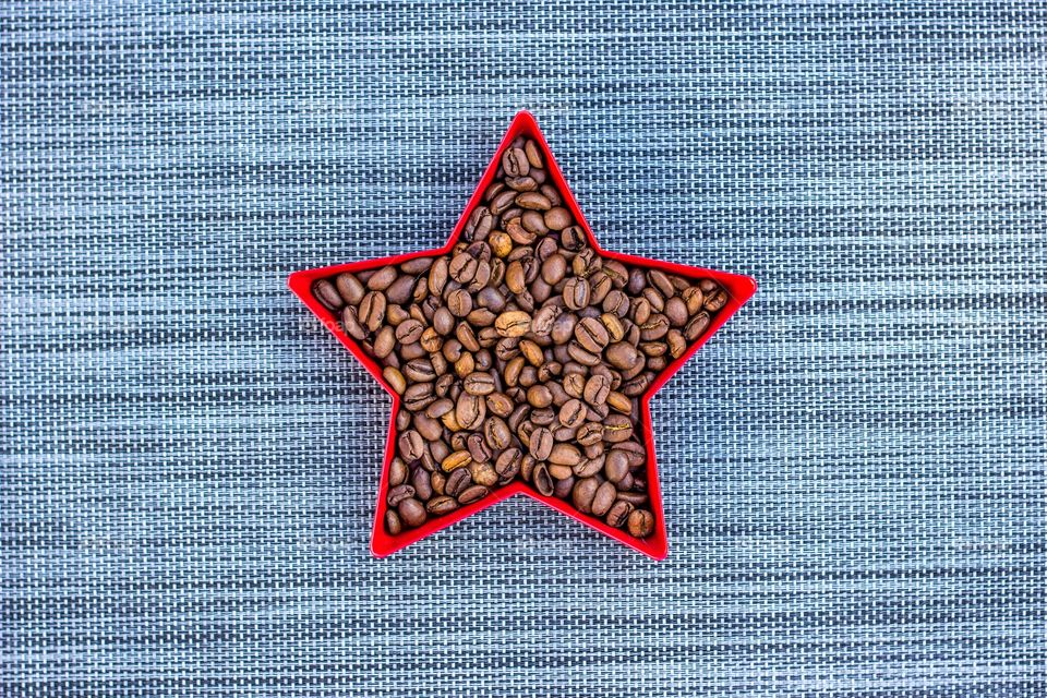 Coffe beans in a red star on a grey background