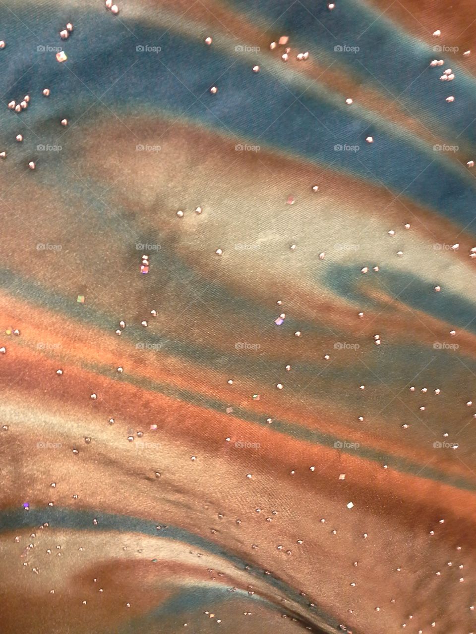 An interesting patterned fabric with beads Incorporated upon it