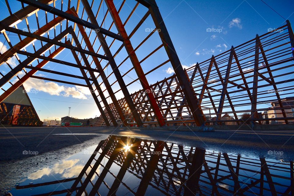 Installation of a fish drying rack in Oslo, Norway during sunset 