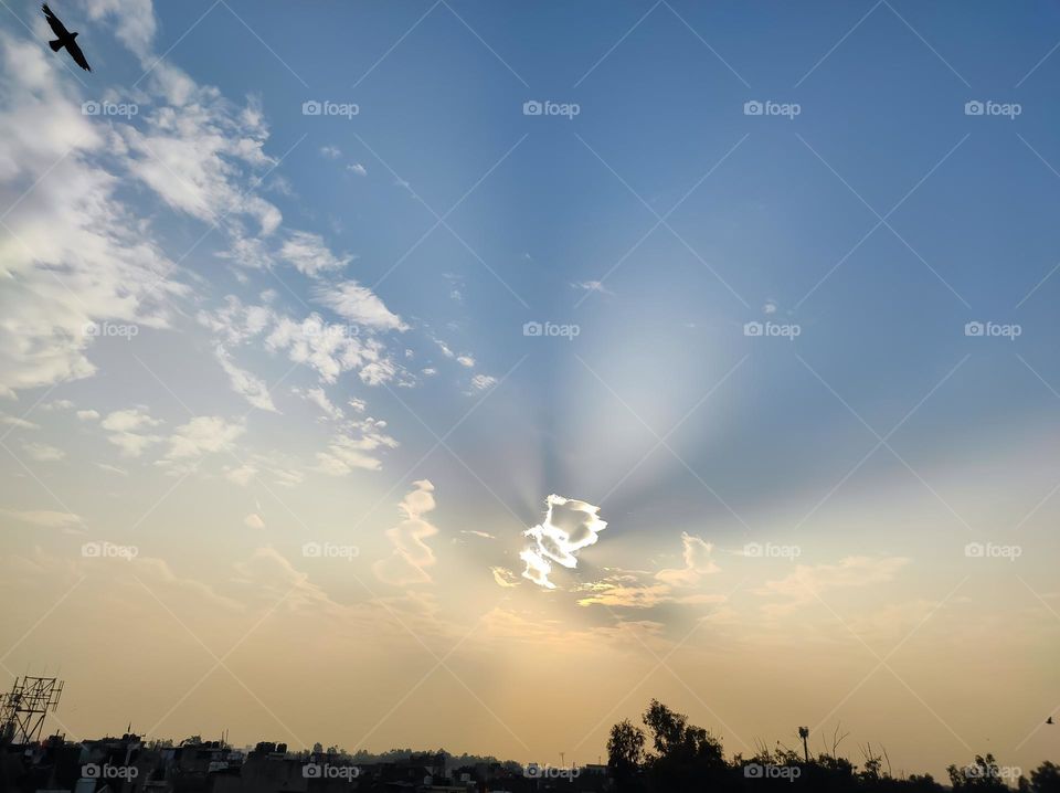 Sun emitting Rays from behind the clouds