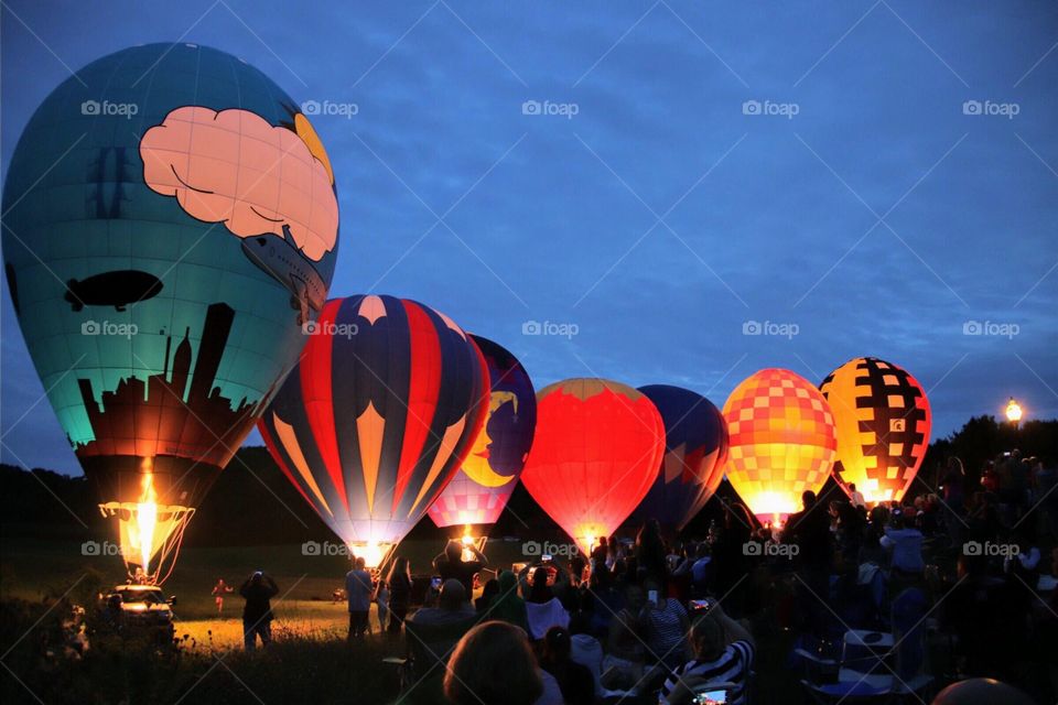 People watching balloons light up at Balloon festival, Debonne Winery, Madison, OH USA at dusk