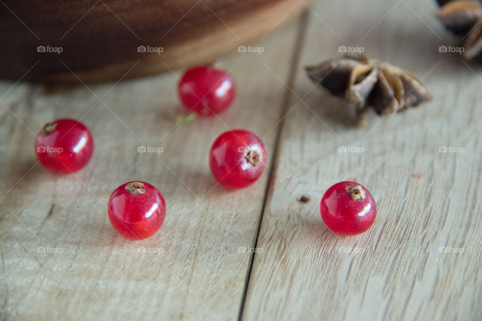 Red currants with spice on table