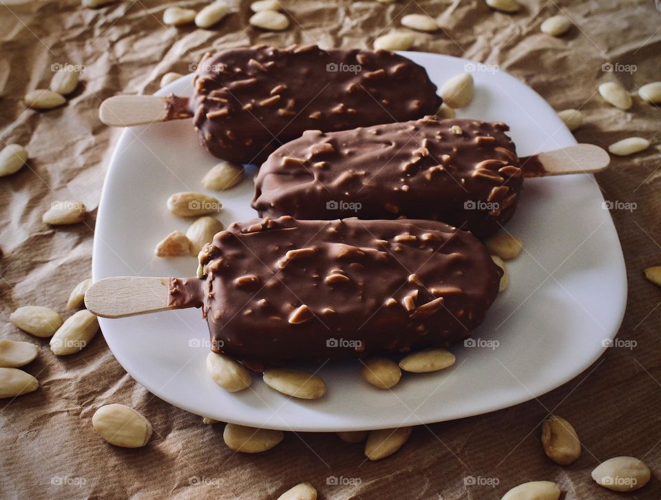 ice cream on a stick with chocolate and mandorle