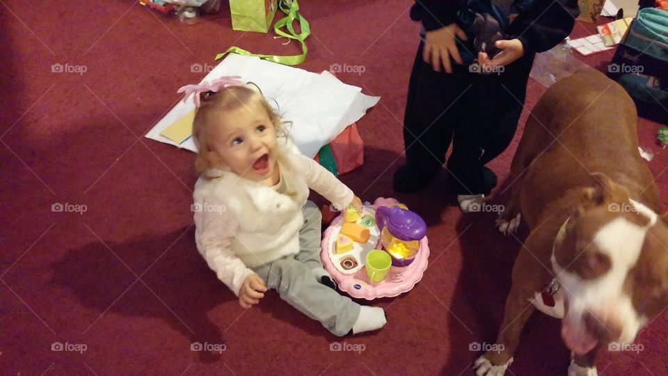excited baby girl playing with toy