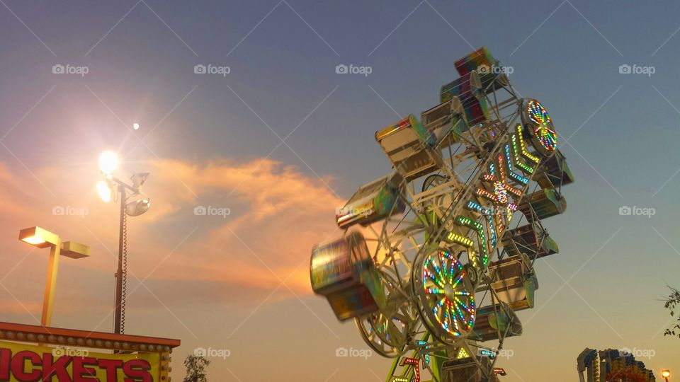 zipper ride at a fair or festival during sunset