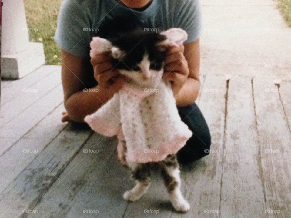 This photo was taken about 35 years ago of my kitten. Frisky was wearing a crocheted baby doll dress.