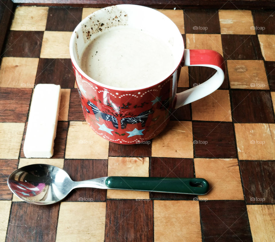 A morning snack: coffee and cheese on a chess board