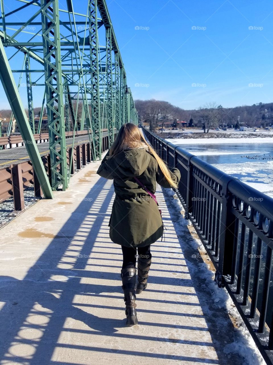 Girl walking on a bridge