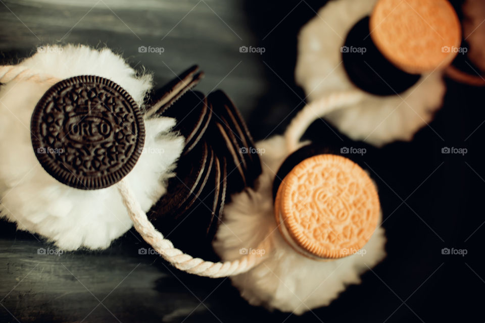 Cute and fun Oreo Cookie art photography contrasts of black and white with normal and thin Oreos on pompon puffs 