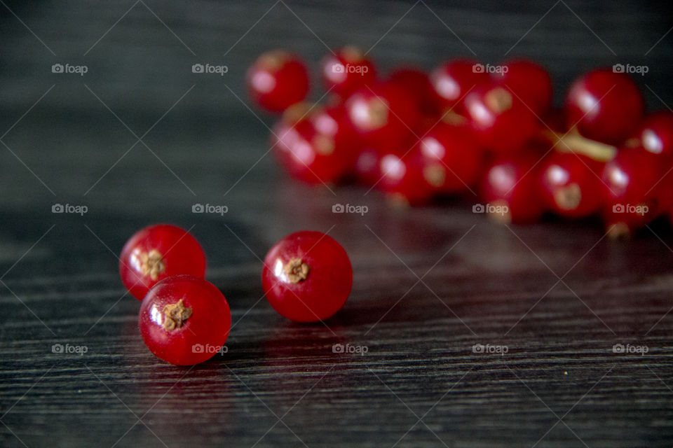 Red currants on wooden table