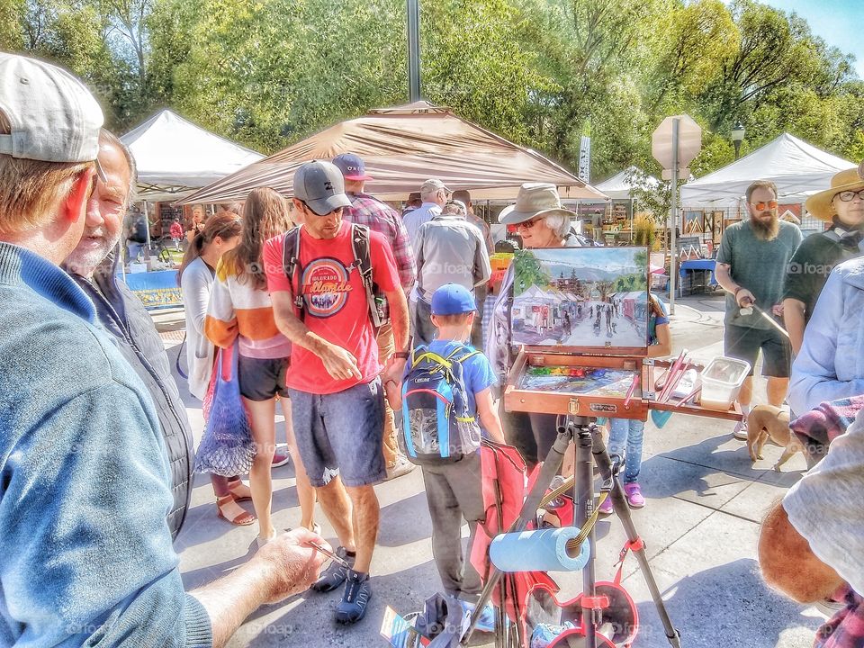 open air farmers market in colorado where people gather. autumn scene in rural small town with artisans and farmers selling their goods to both locals and travelors