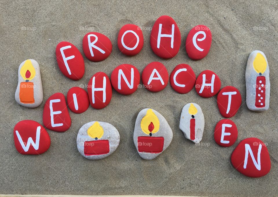 Frohe Weihnachten, german Merry Christmas on colored stones