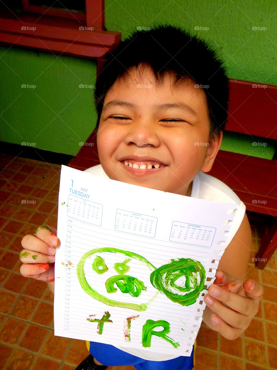 little boy showing off his drawing