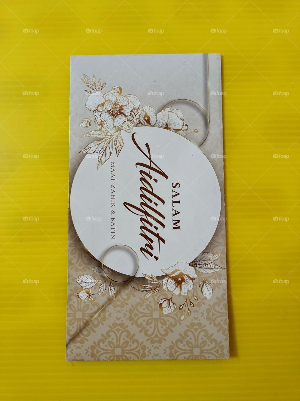 Raya money packet on yellow background.Above close view of a hari raya packet for Hari raya Aidifitri celebrations.