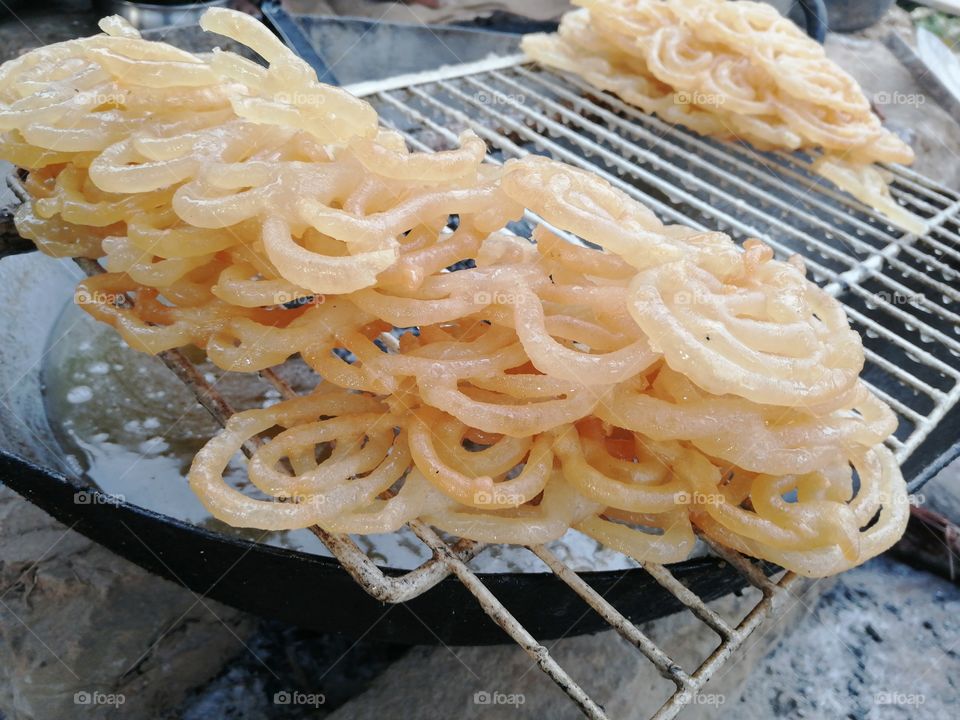Delicious Fresh Indian sweets jalebi made by maida, suger syrup extensively eaten  during festivals and occasions.