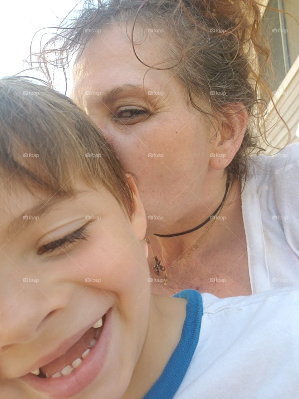 my son loves momma's kisses look at that handsome boy's smile.
