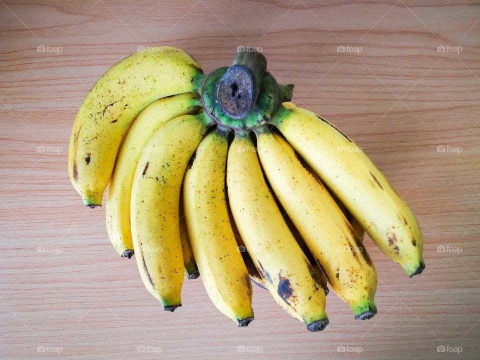 Ripen bananas on the wooden table