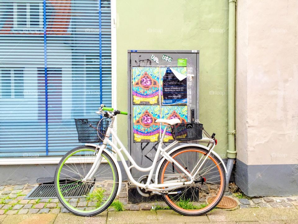 Bicycle leaning on a wall in pastel colors 
