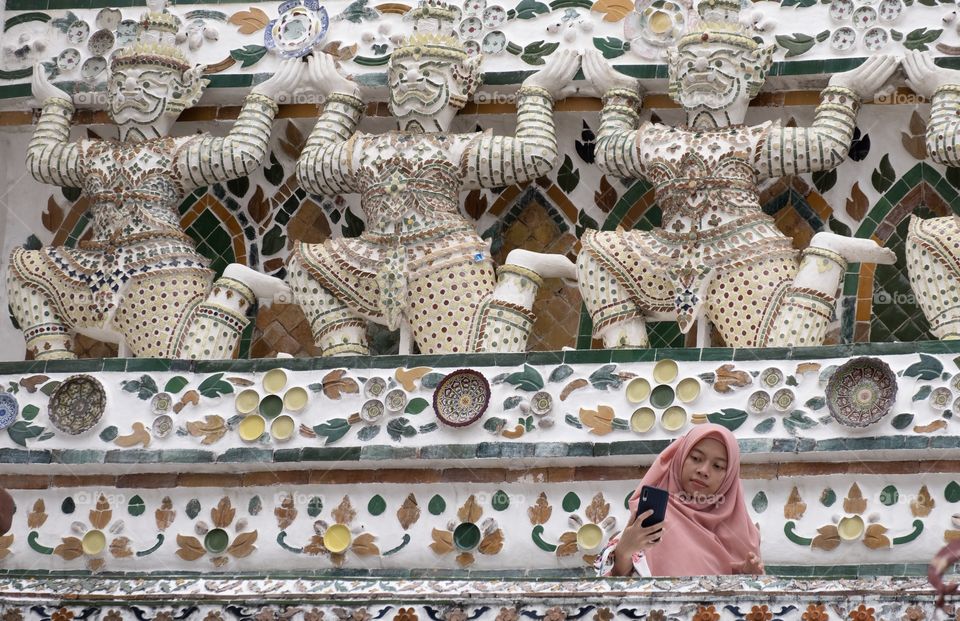 Beautiful Symmetry composition and leading line of Giant statue make the famous pagoda of  Temple of  Dawn (Wat Arun) is very interested for tourists, Bangkok Thailand