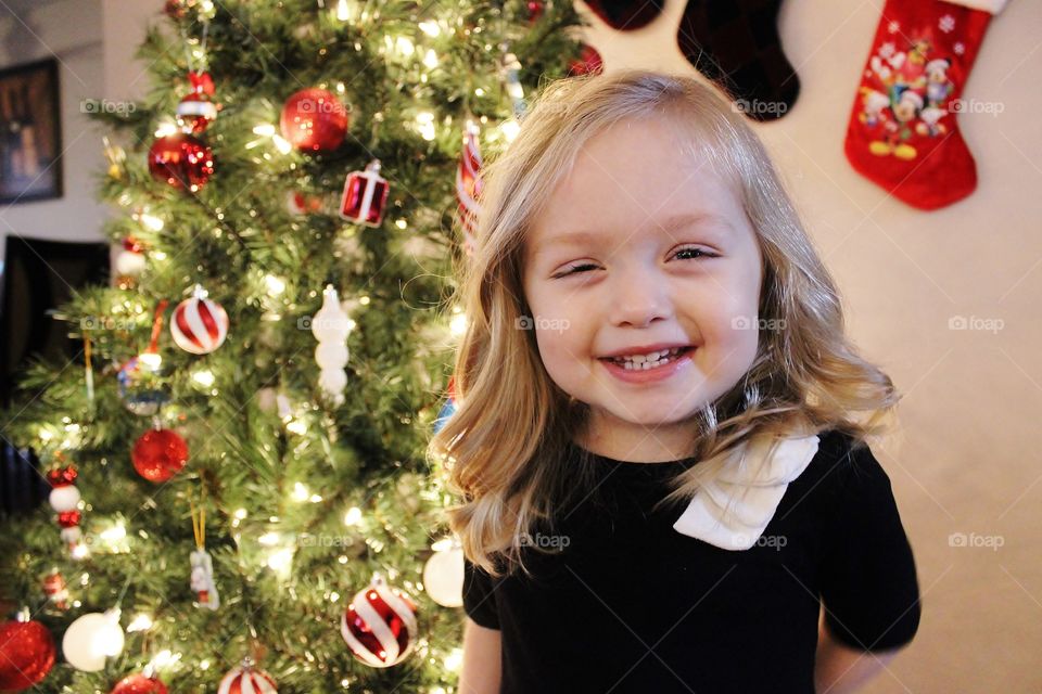 Portrait of smiling girl against christmas décor