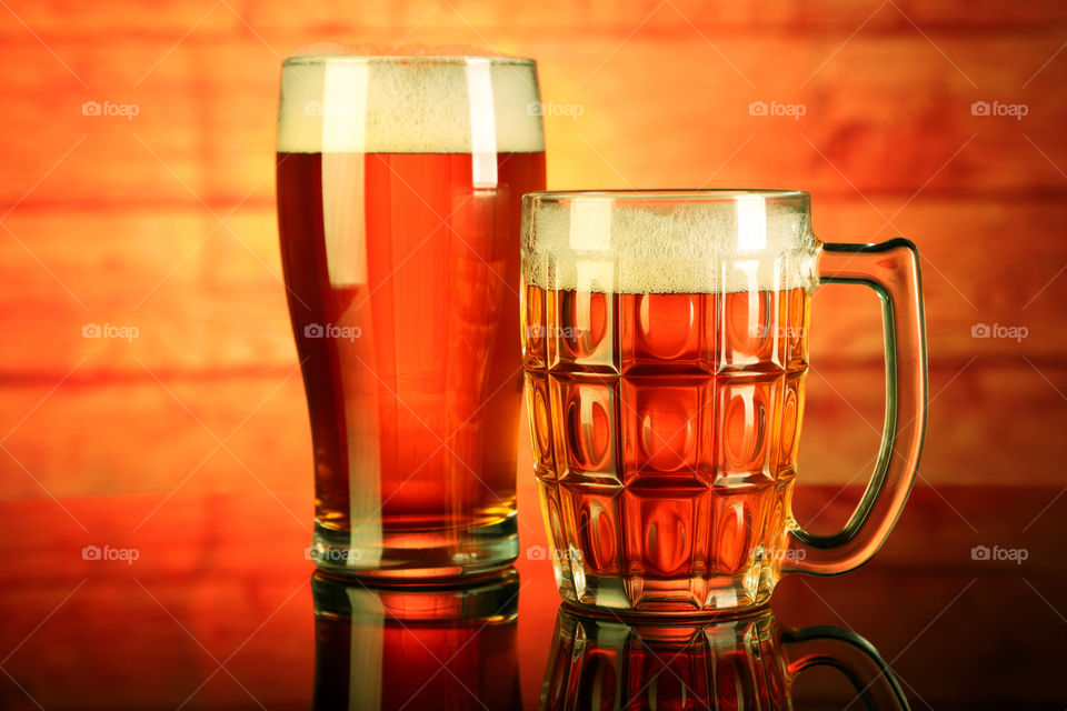 Beer glass / mug with froth and reflection