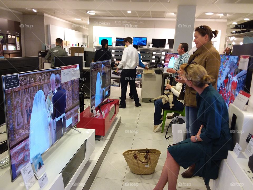 Customers watching the Royal wedding on Samsung's premium 4K Ultra High Definition TV at Peter Jones department store Sloane square Chelsea Kings road London