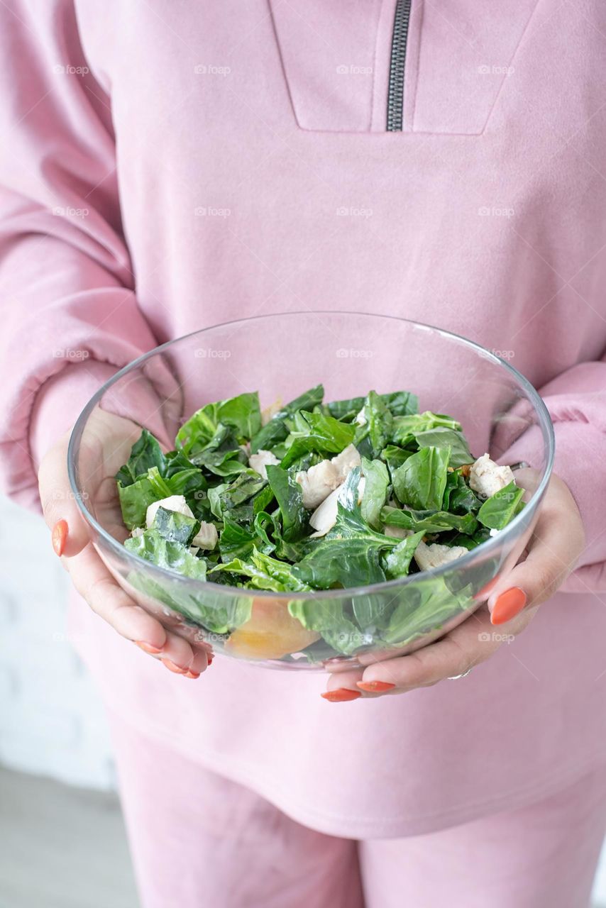 woman holding salad bowl