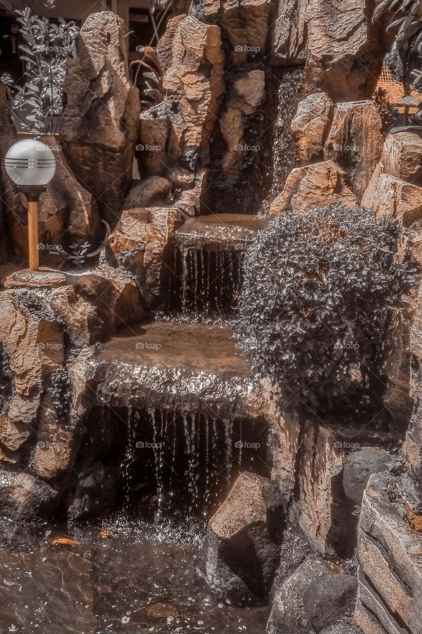 Full frame shot of fountain. Water fountain. Water. Decoration. Park. Public places. Holiday. Light. Steps. Rock. rocks. Garden. Park. Playground. Genre. Fall. Grass. Beautiful. Fresh. Photography.