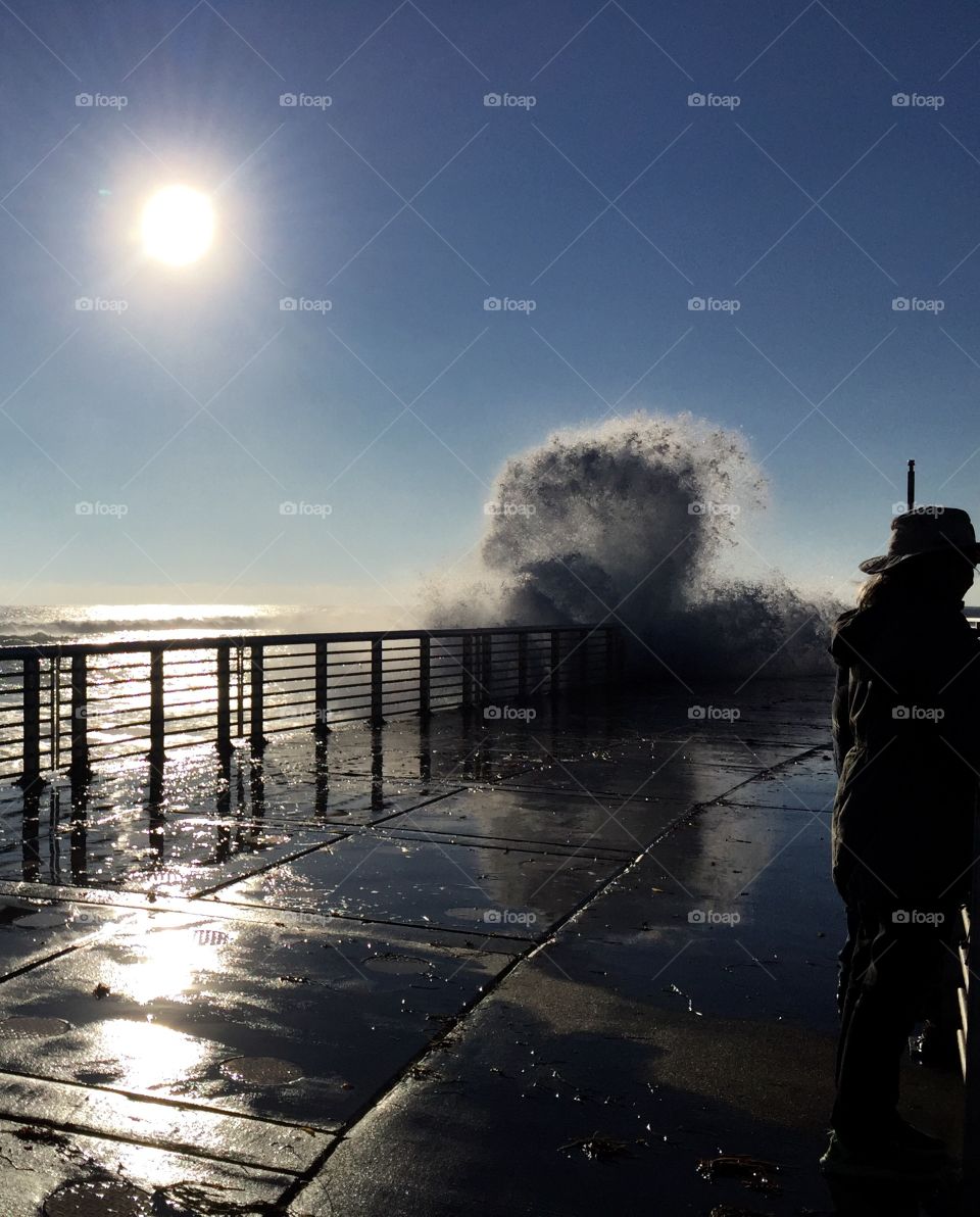 Fool moon giving rise to gigantic waves crashing against the pier at Boynton beach inlet FL