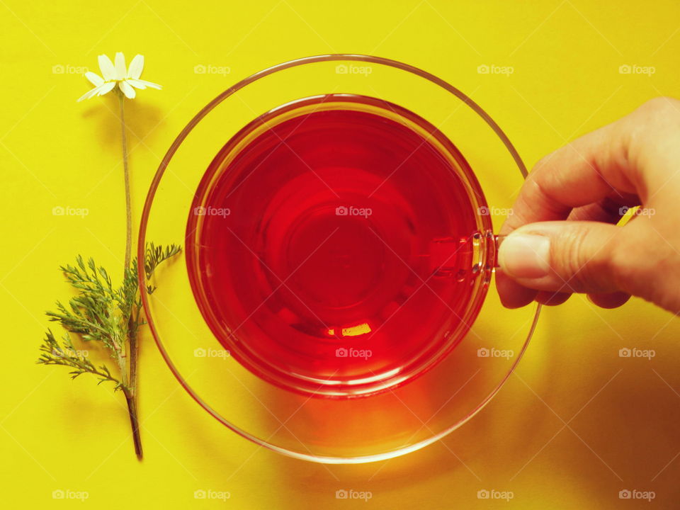 Fruit tea. Fruit tea with camomile on yellow background