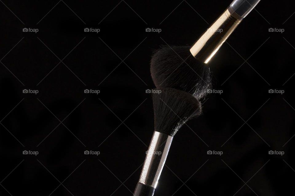 Cosmetic brushes on black background