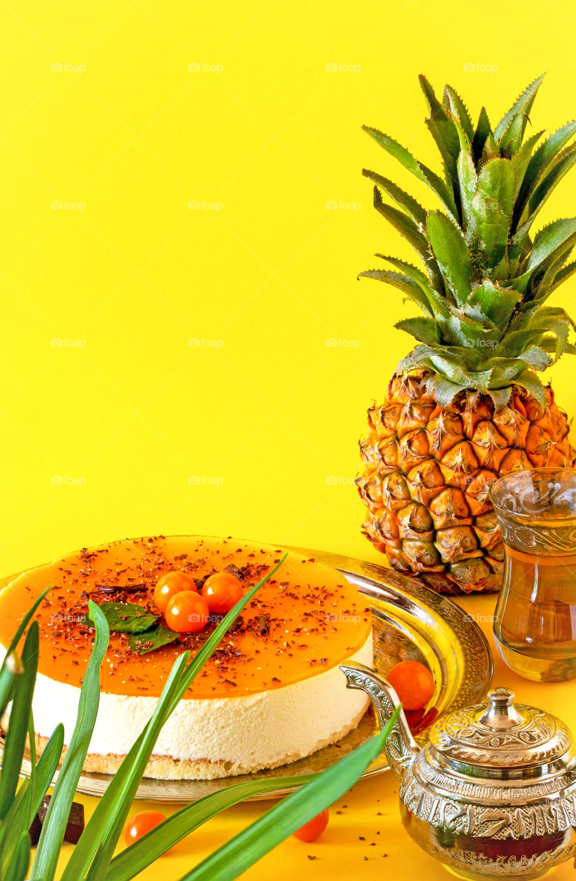 Bright yellow pineapple pie made from natural ingredients, consisting of tender souffle, cottage cheese and pineapple puree. Healthy pastries with exotic fruits. Food photo, vertical orientation, copy space
