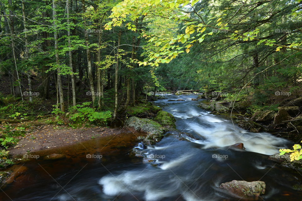 Waterfall in lush green forest in Michigan's Upper Peninsula 