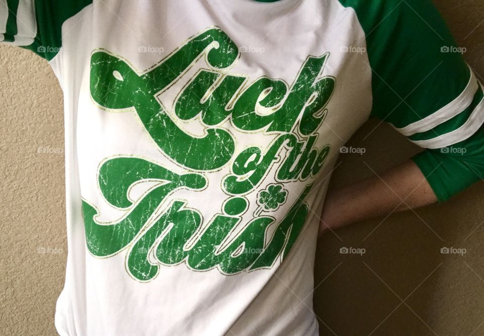 A girl wearing a St. Patrick’s Day luck of the Irish white and green T-shirt in celebration of St Patrick’s Day. USA, America 